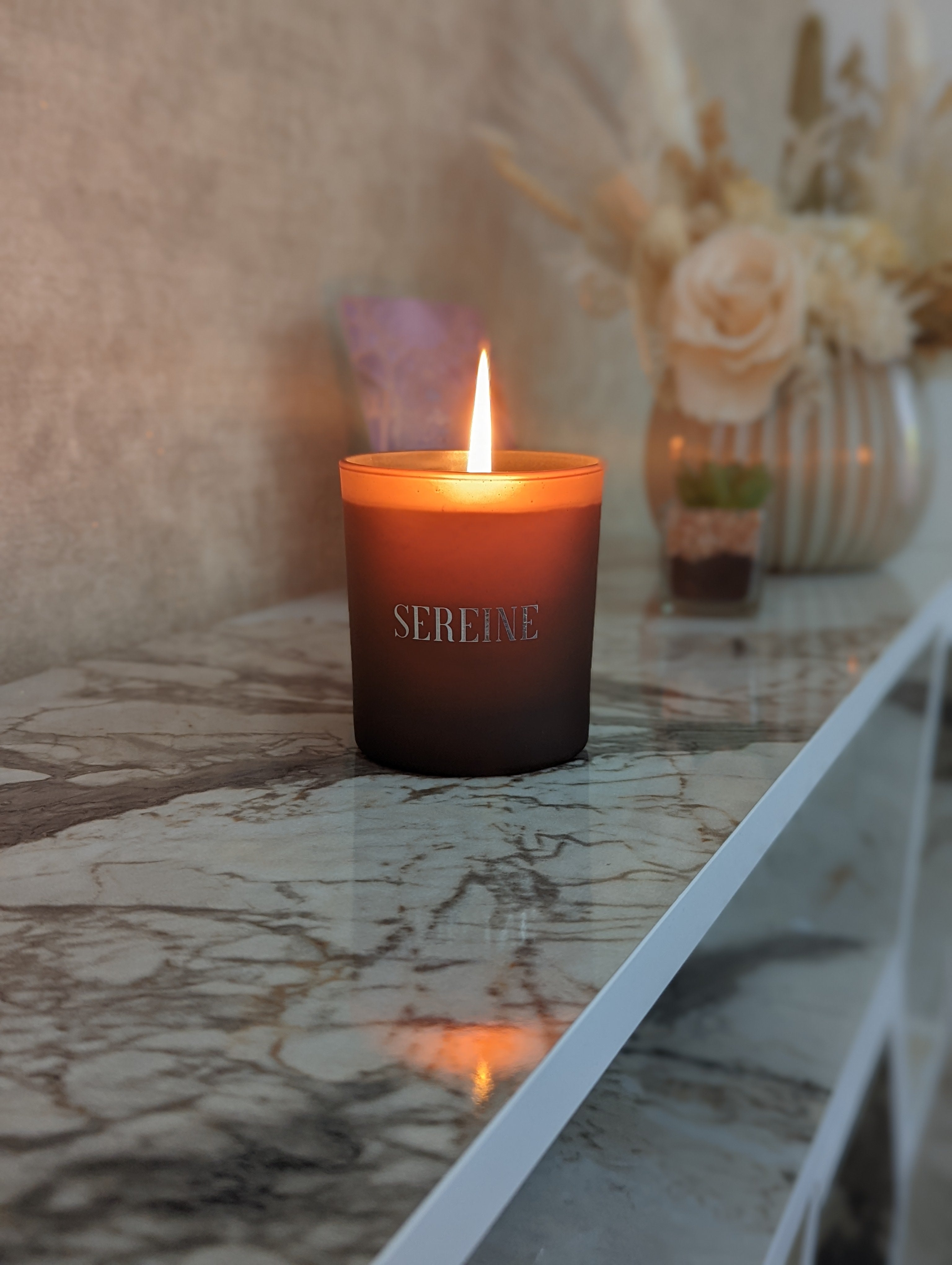 Luxury candle lit on marble surface