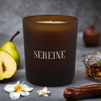 Pure luxury candle surrounded by ingredients