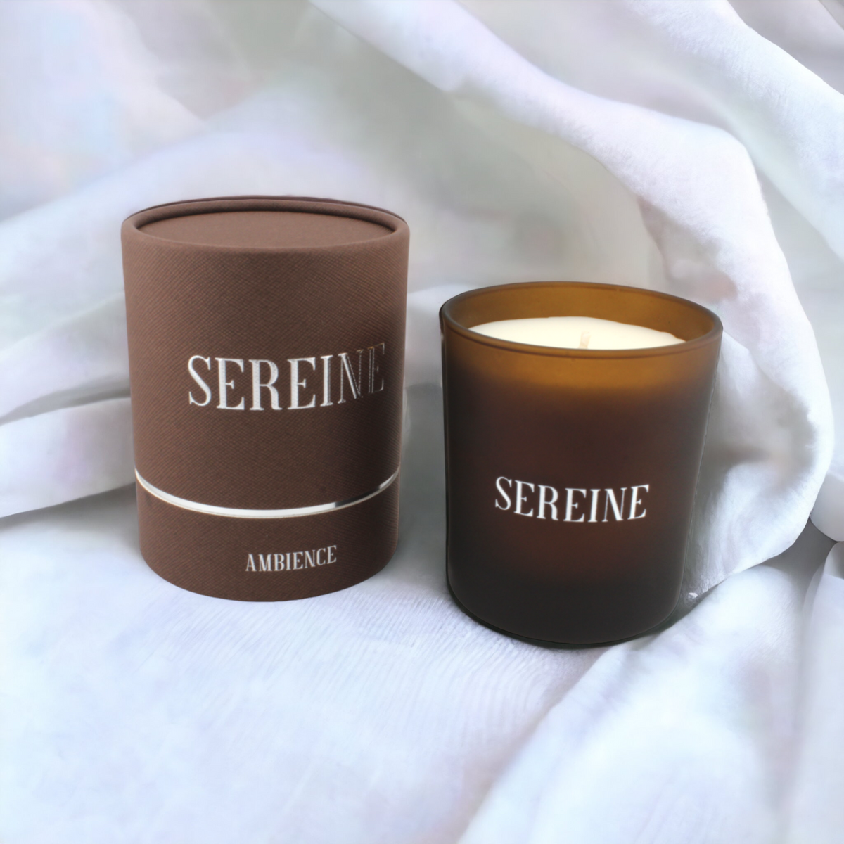 Ambience luxury candle on white fabric