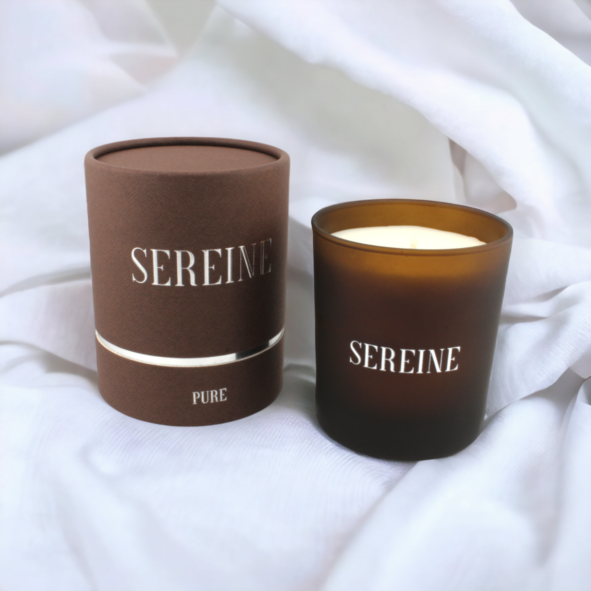 Pure luxury candle on white fabric