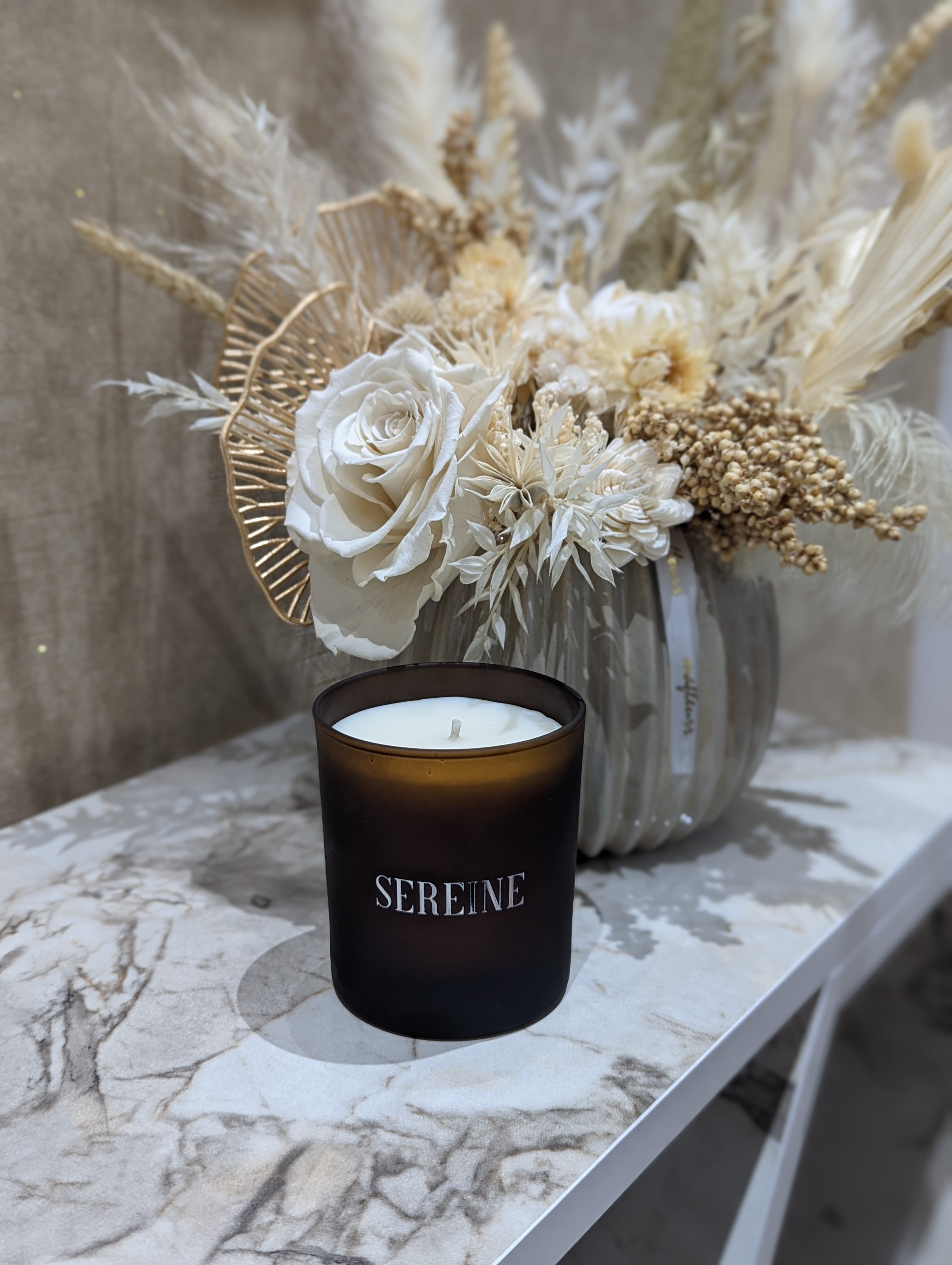 Luxury candle with vase on marble surface